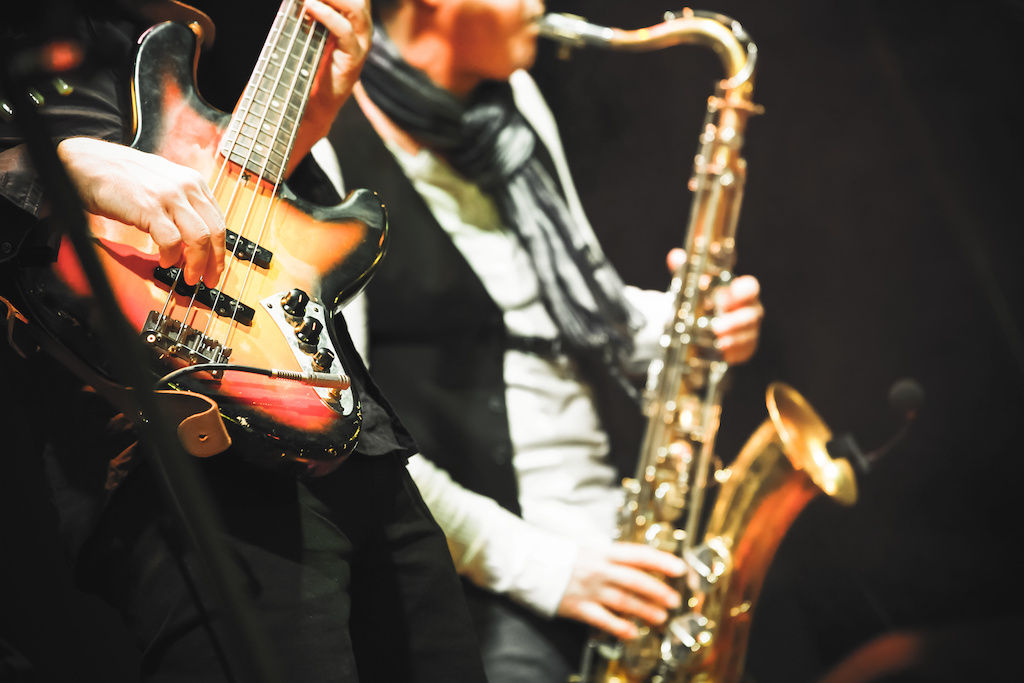 Saxophone and guitar players in a jazz band